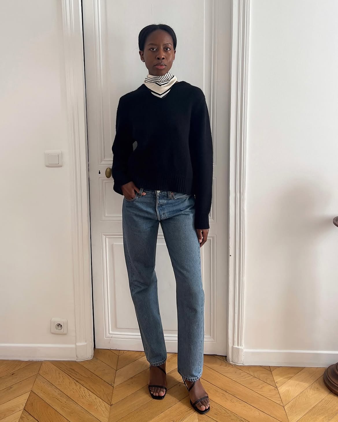 Sylvie Mus wearing a Soft Goat knit with a silk scarf and blue jeans.