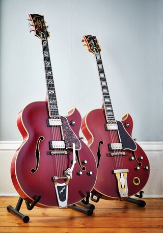 Both of Gibson’s golden-era flagship guitars in a custom Cherry finish: a 1964 Super 400CES with factory-fitted Bigsby and 1961 L-5CES with a Varitone switch.