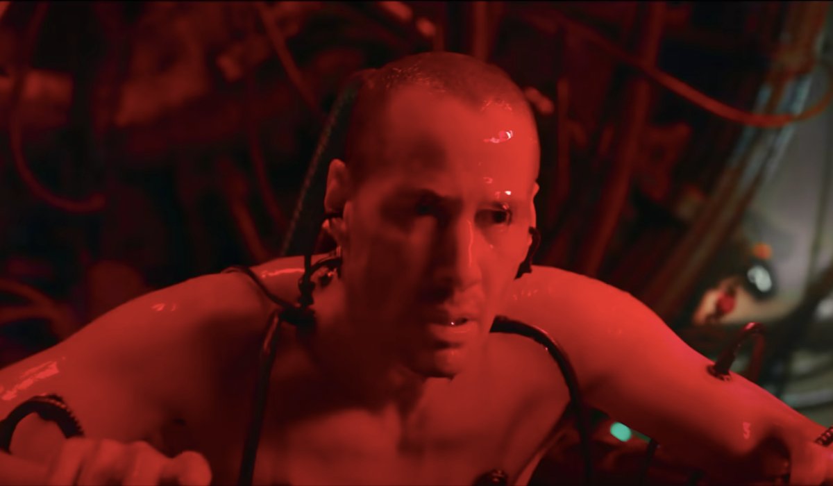 Keanu Reeves awakens connected to a machine pod in The Matrix Resurrections.