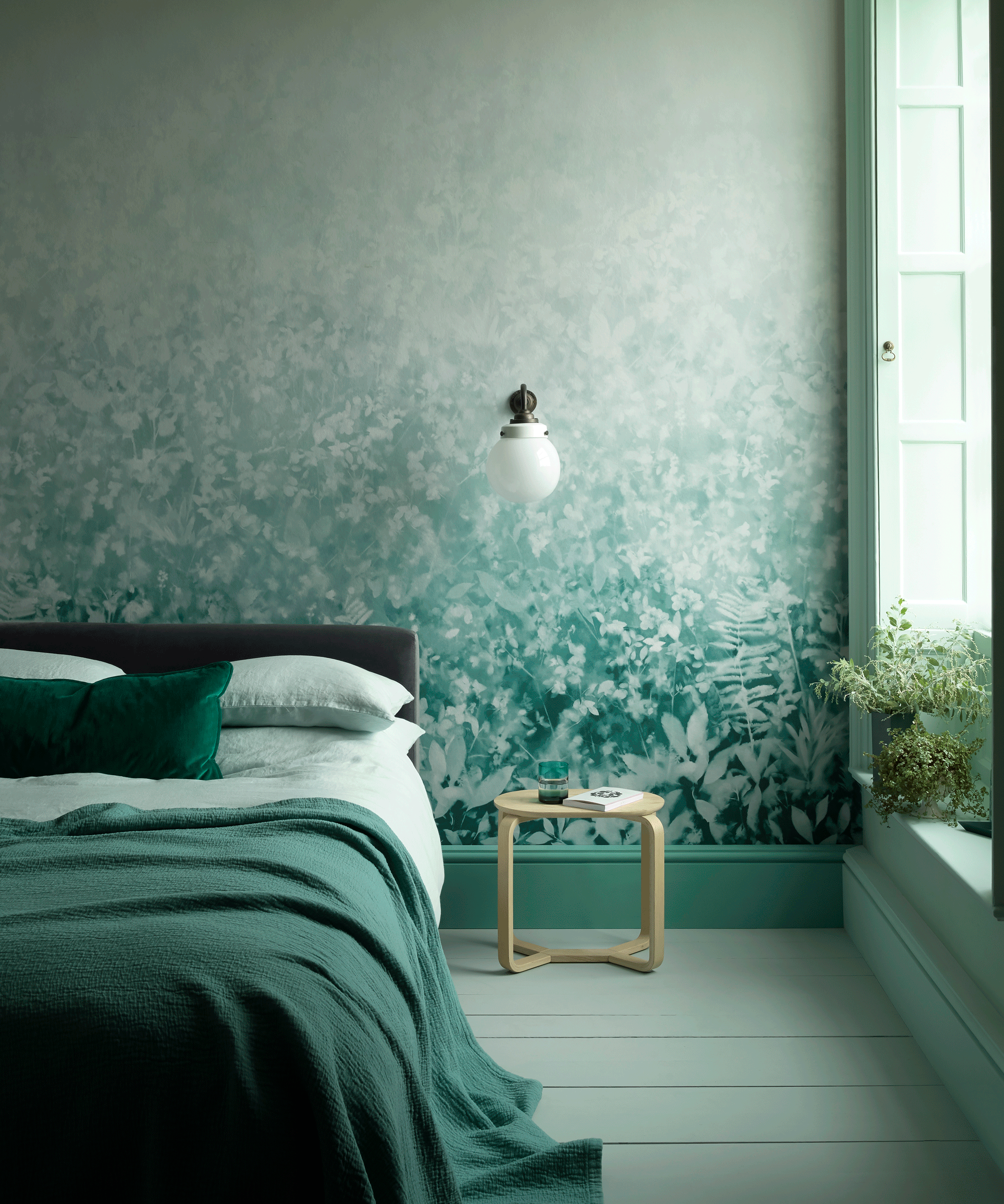 Bedroom with teal patterned wallpaper