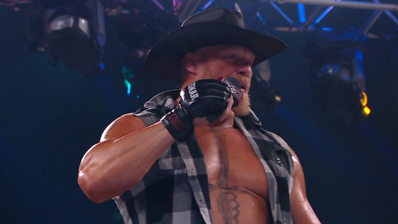 Brock Lesnar talks into the microphone with a cowboy hat at SummerSlam 2022.