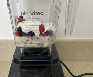 A closeup on a berry smoothie in the Blendtec Designer