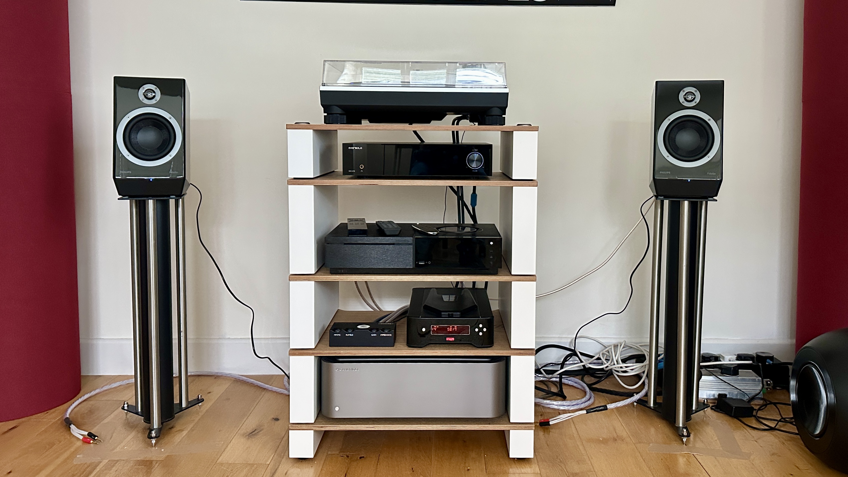 The Philips Fidelio FA3 speakers on stands, on either side of a hi-fi rack with various components on it