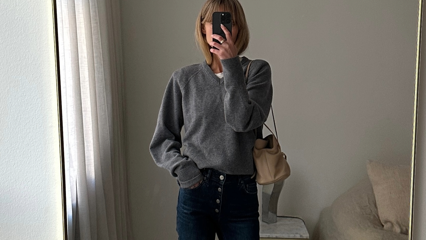 Jeanette Madsen in a grey sweater and Prada bag