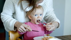 Child being fed a pancake