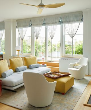 A bright and airy living room with blue and yellow accents