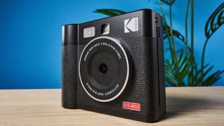 A black Kodak Mini Shot 4 Era 2-in-1 instant camera and printer