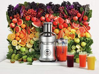 A sage juicer surrounded by fruit and veg