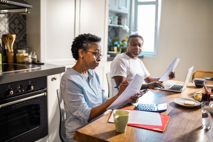 elderly couple sorting paperwork