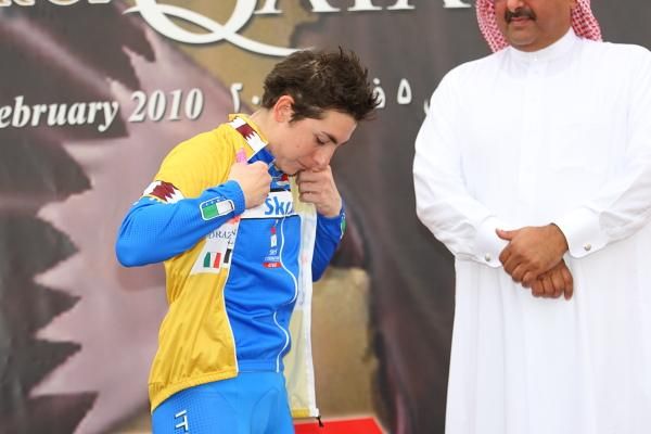 Giorgia Bronzini (Italy) pulls on the leader's golden jersey after Stage 2 in Qatar