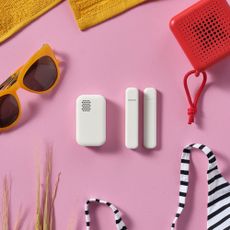 IKEA's new smart sensors together against a pink background