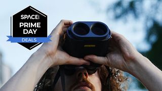 A man looking upwards at the sky with the Fujinon Techno-Stabi TS-L 1640 image-stabilized binoculars and a black Space.com Prime Day badge in the upper left corner.