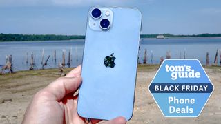 iphone 14 held on the beach with a black friday deal block