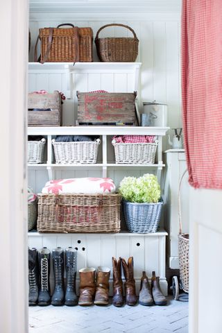 utility room with boots and shelves and baskets with gingham and patchwork