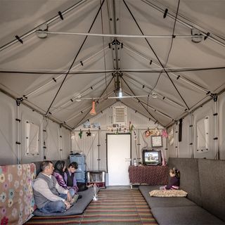 people in shelter with rug flooring