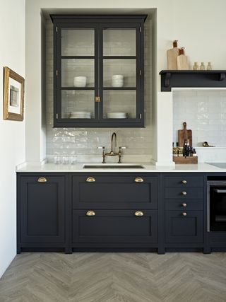 kitchen with shaker style cabinets and white metro tiles by breyers design