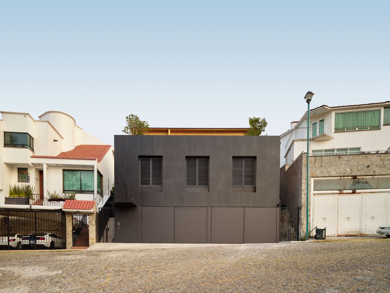 dark and opaque exterior of minimalist mexican home