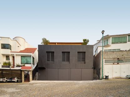 dark and opaque exterior of minimalist mexican home