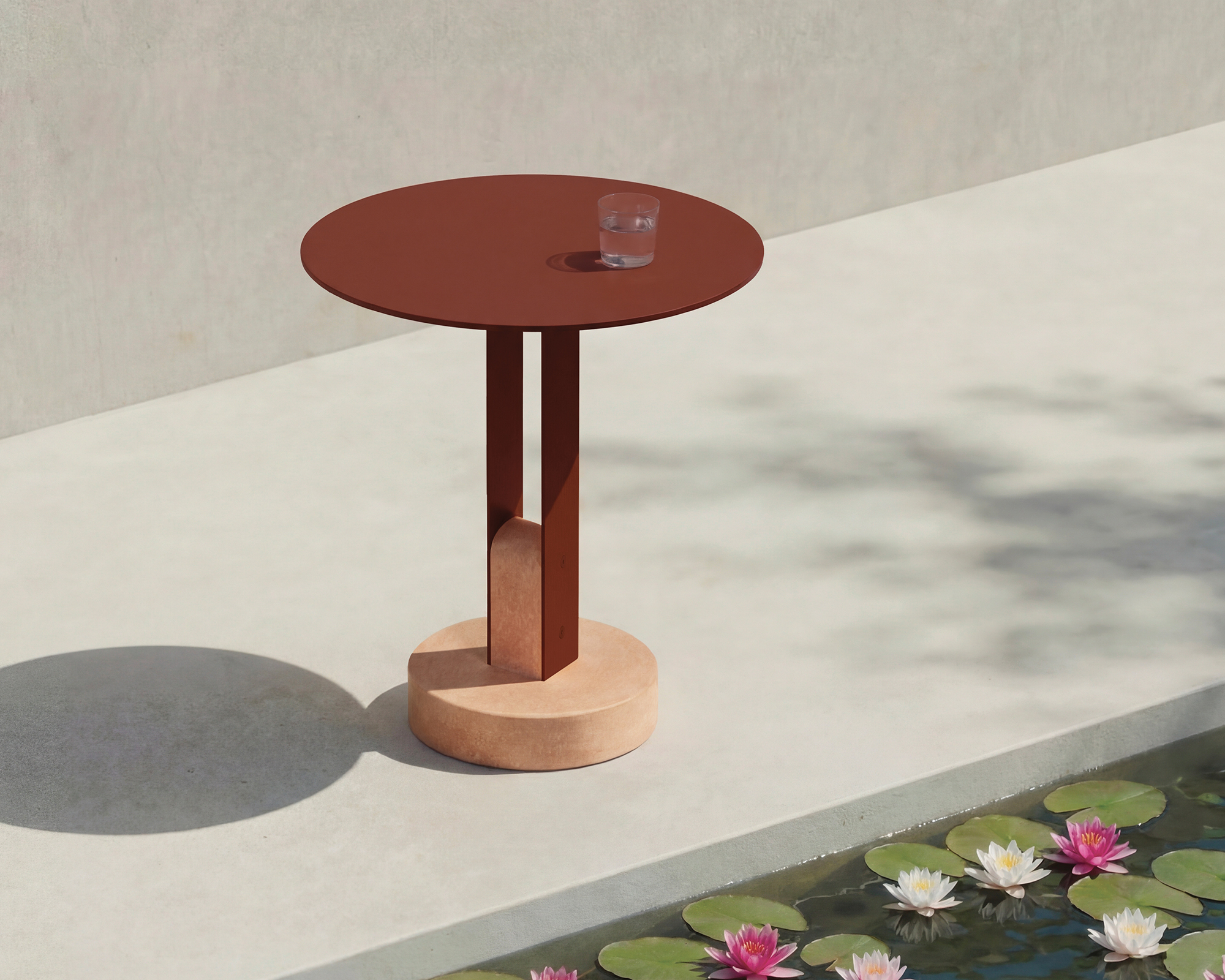 powder coated round table next to a lilypond