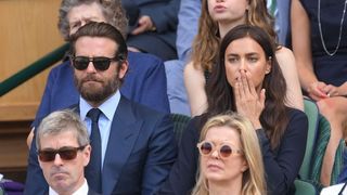 Bradley Cooper and Irina Shayk looking upset in the crowd at Wimbledon