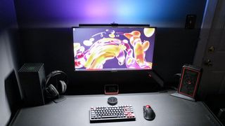 The Quntis RGB Pro+ illuminating a desk setup at night