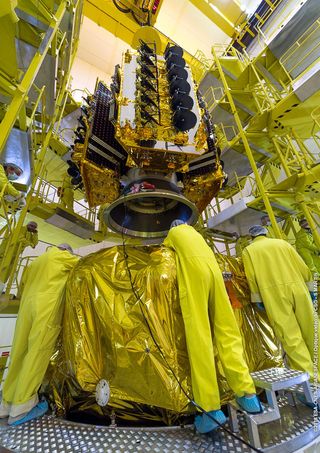 Shrouded in gold-colored thermal insulation, four O3b communications satellites are positioned atop the Soyuz rocket's Fregat upper stage in the S3B payload preparation facility at the Guiana Space Center in Kourou, French Guiana.