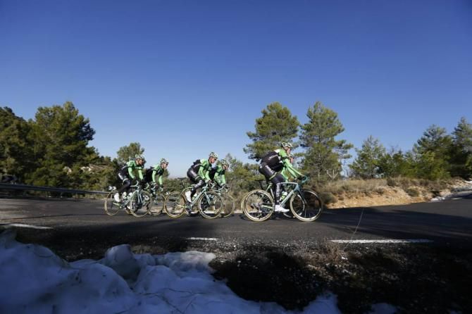 Snow lines the sides of the roads as the riders start to climb