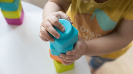 An infant with building blocks