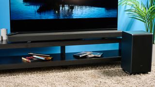 The Sharp 5.1.2 HT-SBW55121 Soundbar photographed in front of a blue background. 