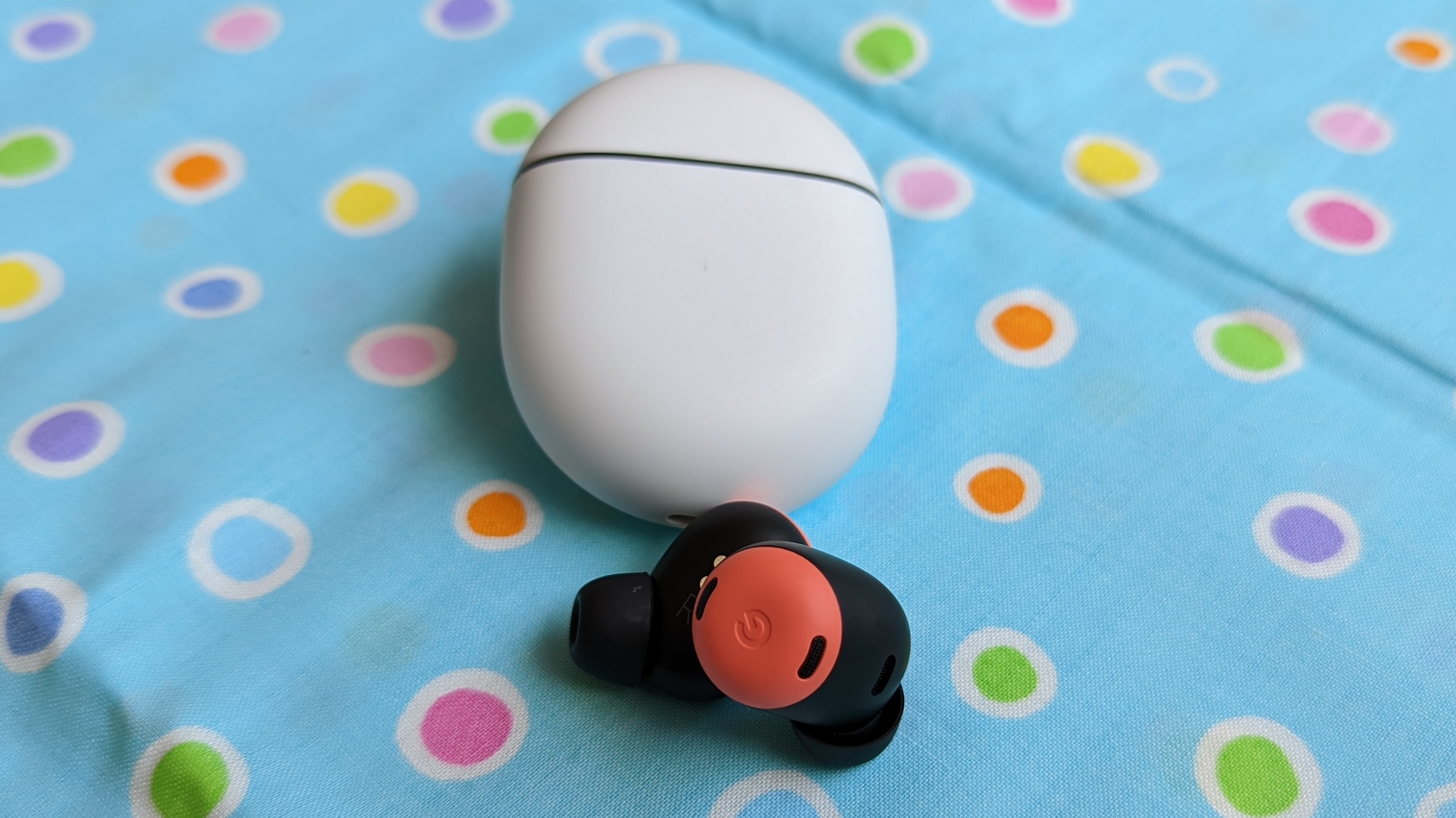 The Google Pixel Buds Pro being displayed atop a polka-dot-designed fabric cloth