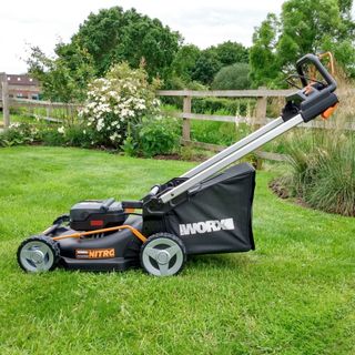 Worx WG749E 46cm Cordless Self-Propelled Lawn Mower being tested on a small lawn