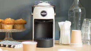 Lavazza A Modo Mio Jolie Plus pod coffee machine in white, sitting on kitchen counter