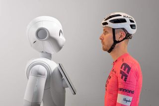 A robot and Josh - in cycling kit - stare each other down