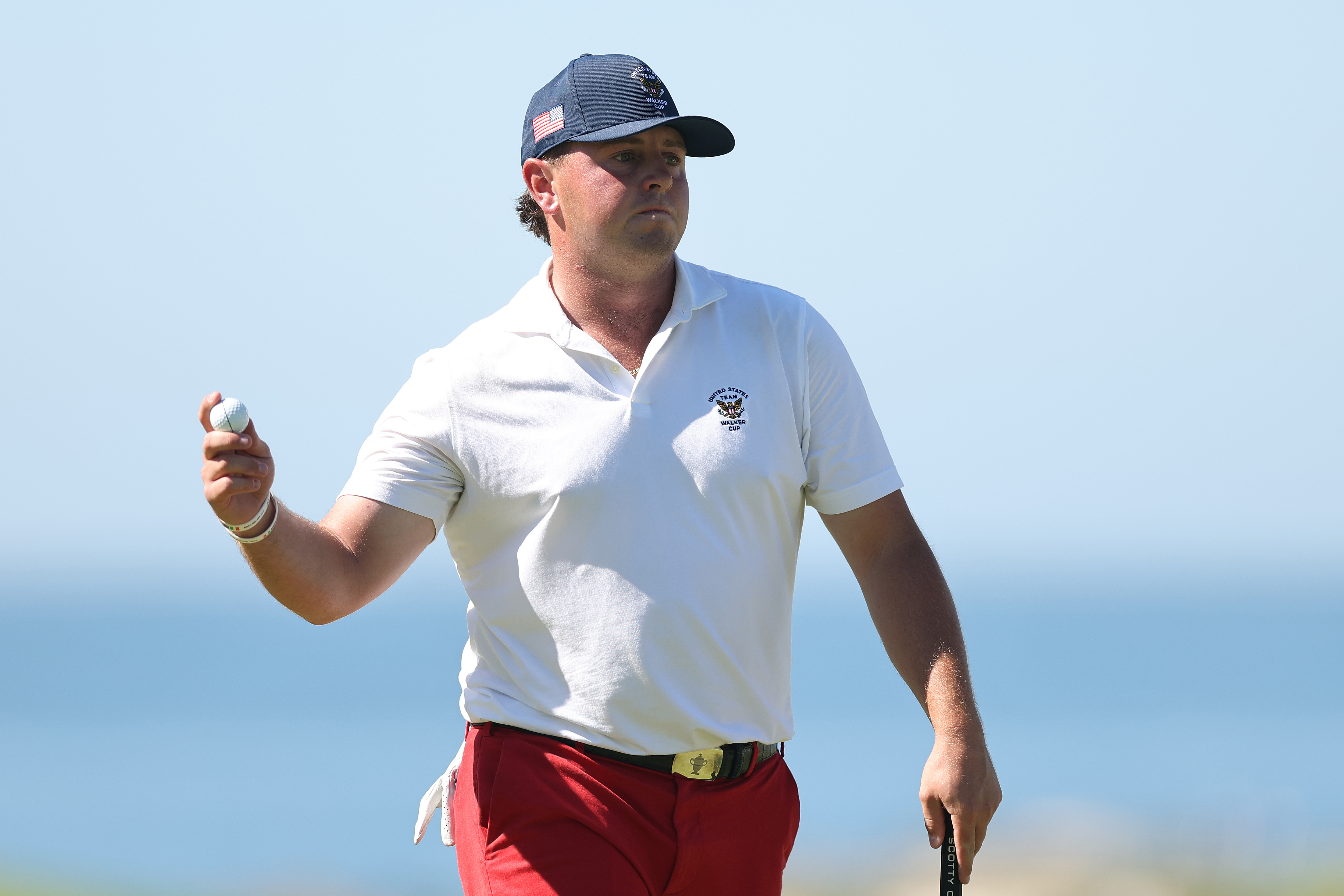 Jase Summy waves to fans after holing a putt