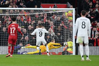 Caoimhin Kelleher of Liverpool saves a penalty from Kylian Mbappe of Real Madrid during the UEFA Champions League 2024/25 League Phase MD5 match between Liverpool FC and Real Madrid C.F. at Anfield on November 27, 2024 in Liverpool, England.