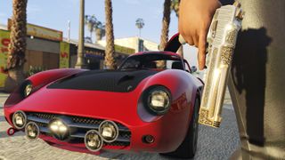 red car and gun in man's hand in GTA V