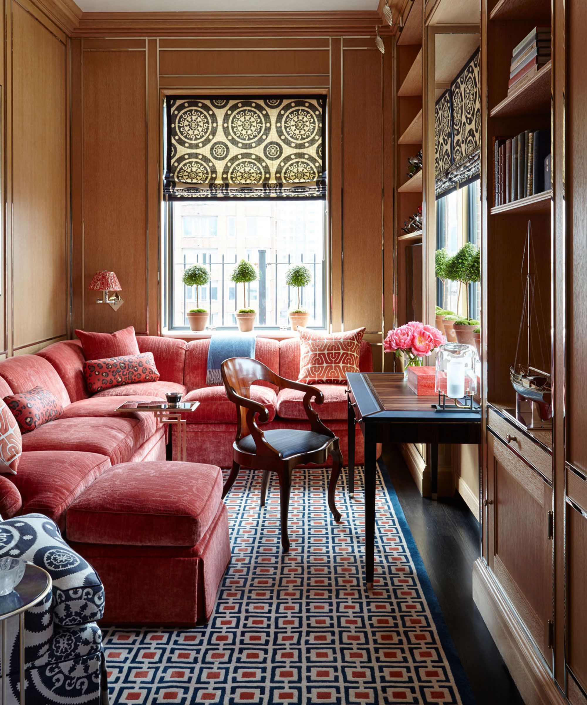 snug room ideas with l-shaped pink sofa and cushions with wood panel wall