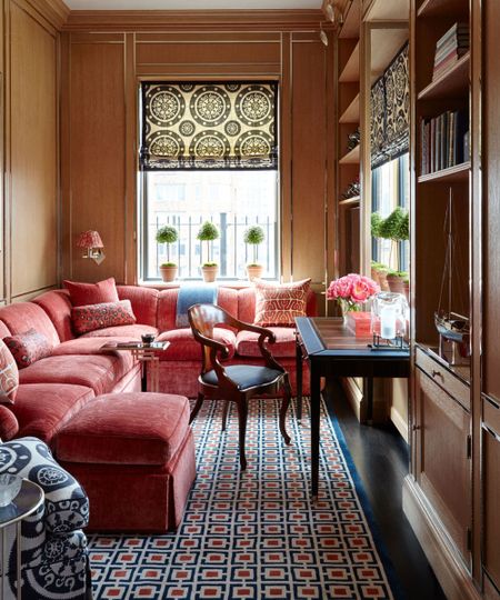 snug room ideas with l-shaped pink sofa and cushions with wood panel wall
