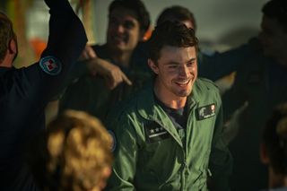 Bogdan wearing astronaut overalls as he smiles through a crowd