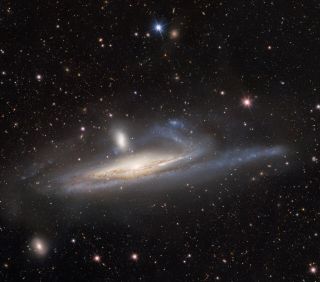 The spiral galaxy NGC 1532, also known as Haley’s Coronet, is caught in a lopsided tug of war with its smaller neighbor, the dwarf galaxy NGC 1531. The image — taken by the US Department of Energy’s (DOE) Dark Energy Camera mounted on the National Science Foundation’s (NSF) Víctor M. Blanco 4-meter Telescope at Cerro Tololo Inter-American Observatory in Chile, a Program of NSF’s NOIRLab — captures the mutual gravitational influences of a massive- and dwarf-galaxy merger.