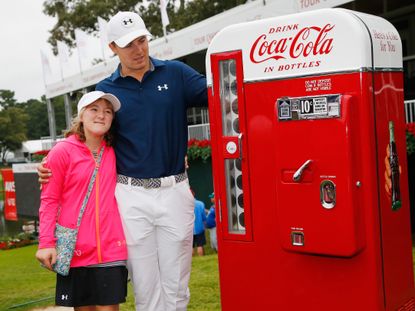 Jordan Spieth with his sister Ellie inspecting one of the prizes for winning the Coca Cola sponsored 2015 Tour Championship/ Credit: Getty Images