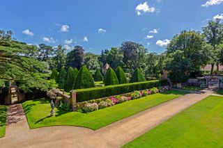 The giant yew pyramids in the Great Court at Athelhampton House, Puddletown, Dorset, England, UK