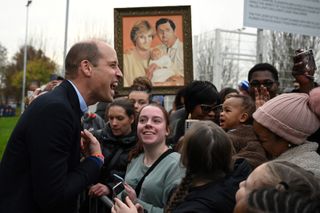 Prince William laughing with well wishers in Manchester Moss Side