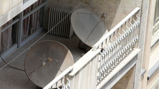 A picture taken on July 24, 2016 shows satellite dishes on a balcony in a northern district of the Iranian capital Tehran.