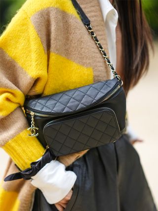 closeup photo of a woman wearing a black leather belt bag