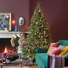mauve living room with christmas tree and fireplace