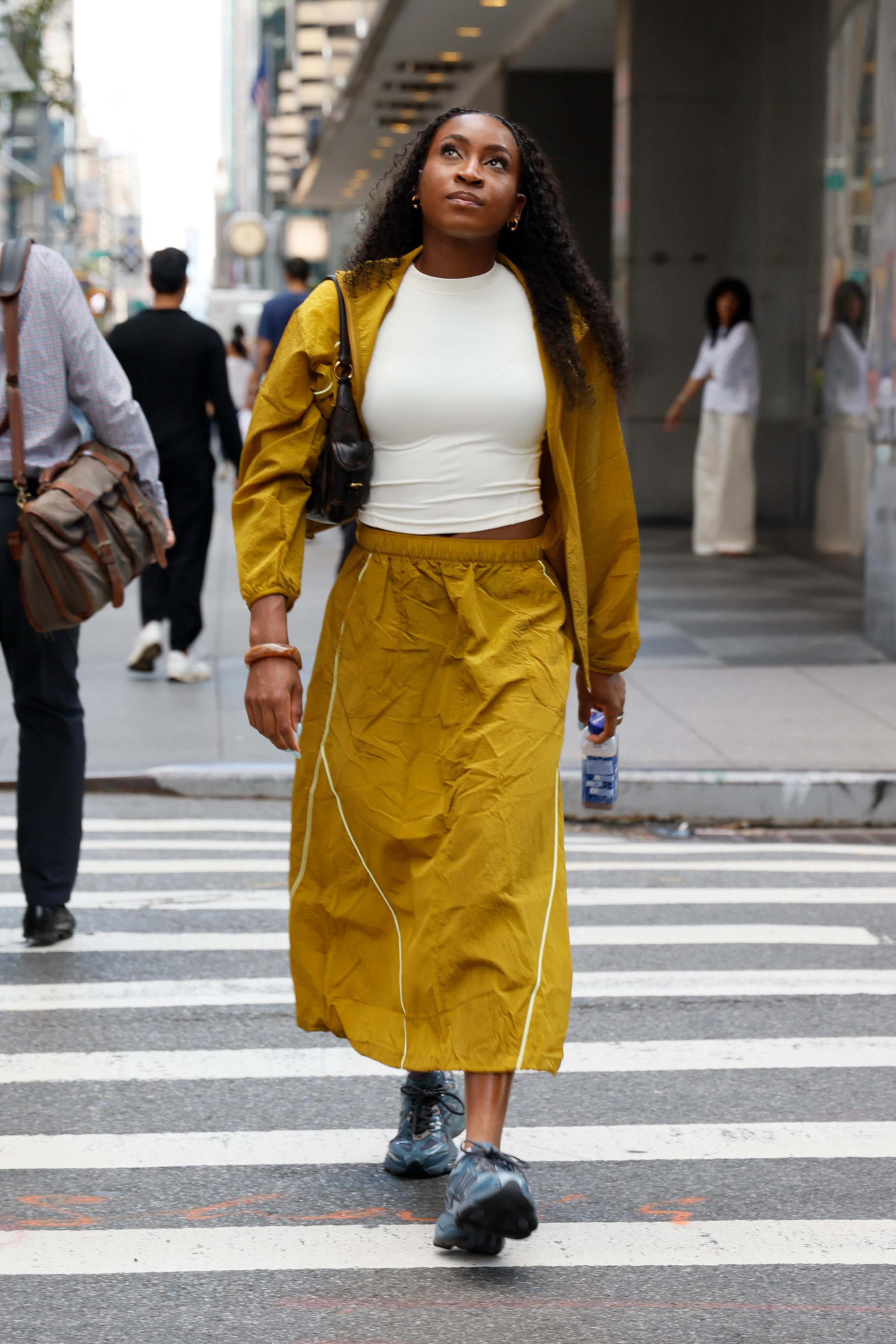 Coco Gauff's track skirt pulled off the mustard yellow color trend for fall with New Balance sneakers