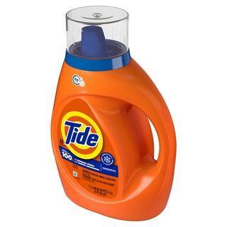 An orange plastic bottle of Tide detergent with a handle built in. A blue cap. 