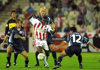 Peter Ofori-Quaye (centre) in action for Olympiacos against Lille in the Champions League in October 2001.