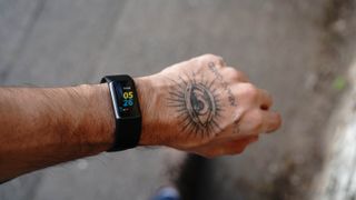 Fitbit Charge 5 being worn by an adult male on his left wrist